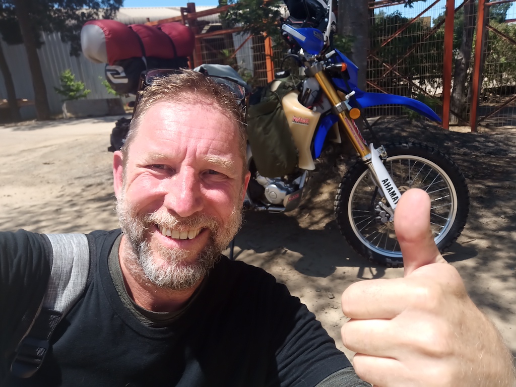 Author giving a thumbs up in front of his motorcycle